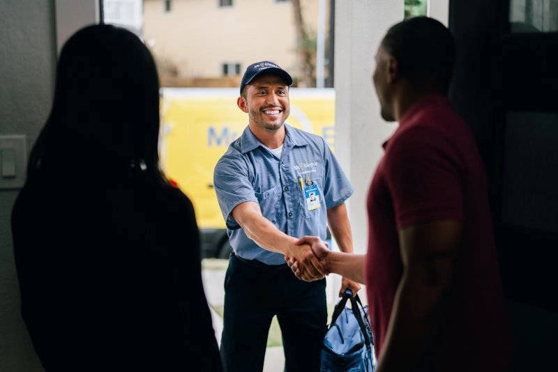 Mr. Electric of Lafayette, LA electrician greeting a family at their door.