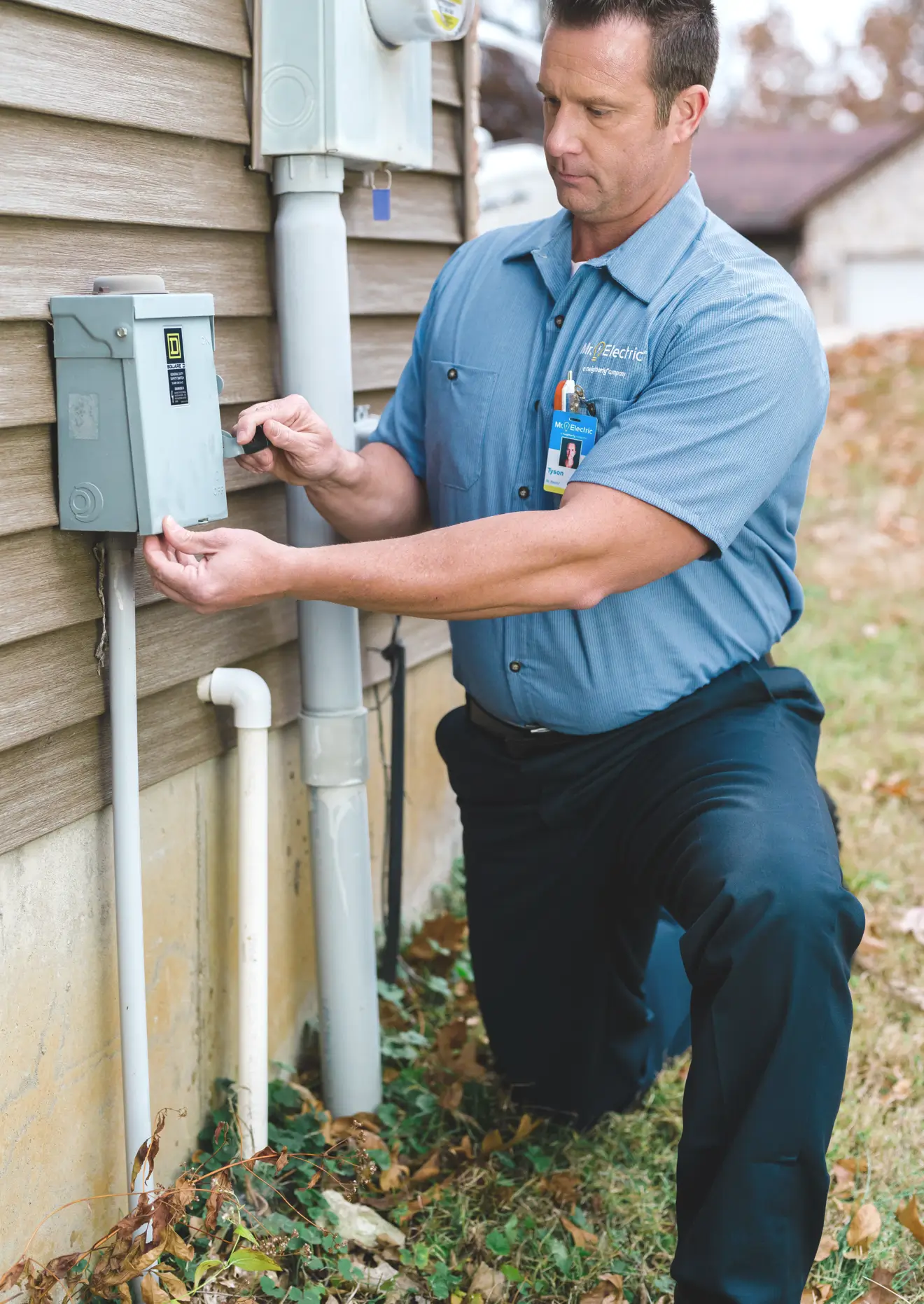 Electrician performing electrical safety inspection on outdoor electrical panel