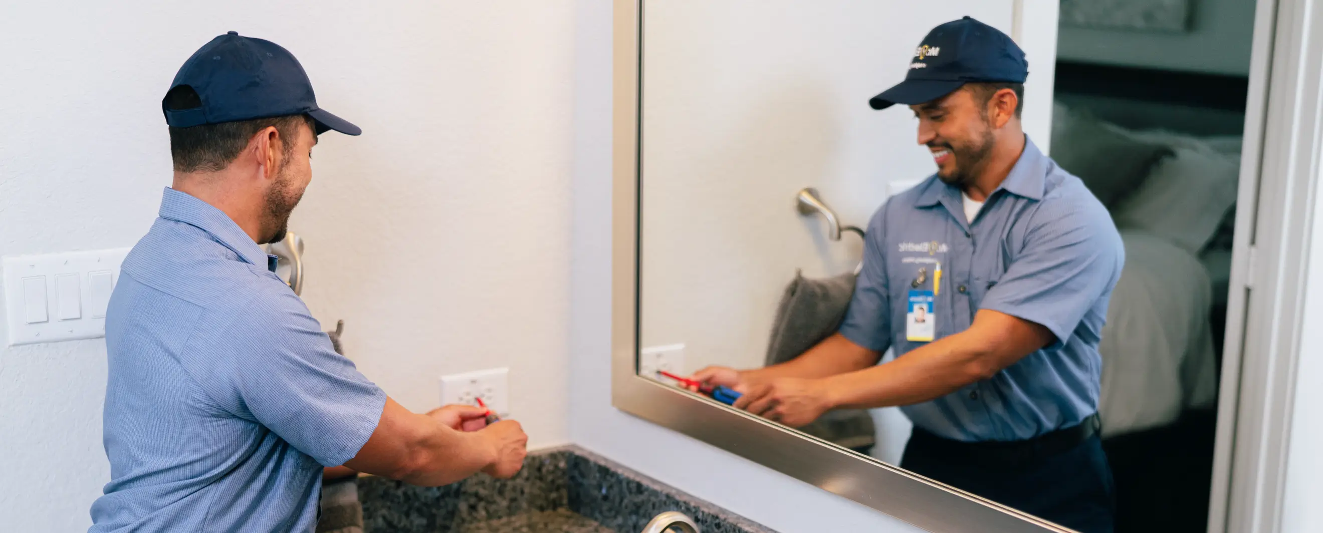 Electrician inspecting bathroom outlet during home electrical inspection
